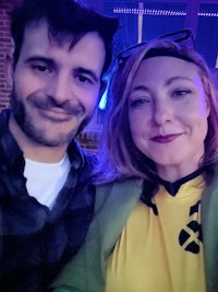 a man and woman posing for a photo at a bar