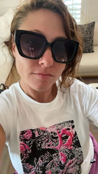 a woman wearing sunglasses and a t - shirt