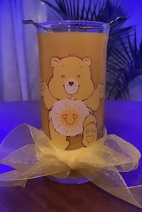 a candle with a teddy bear on it