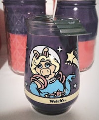 a jar of a candle with a cartoon character on it